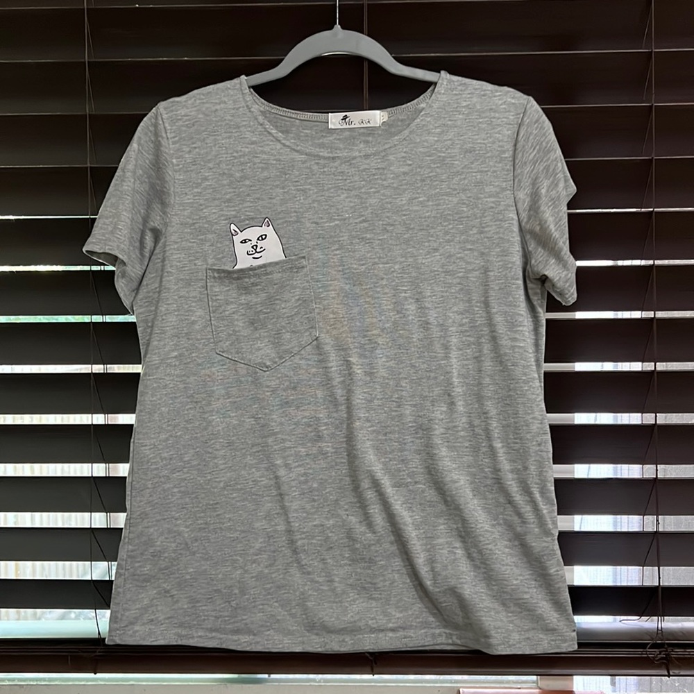 Hidden cat flipping you off in pocket t-shirt